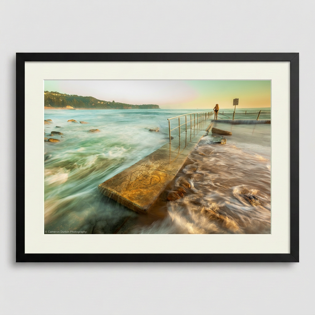 Person standing in Newport ocean pool at sunrise, Northern Beaches Sydney with soft golden light and calm water Black Frame
