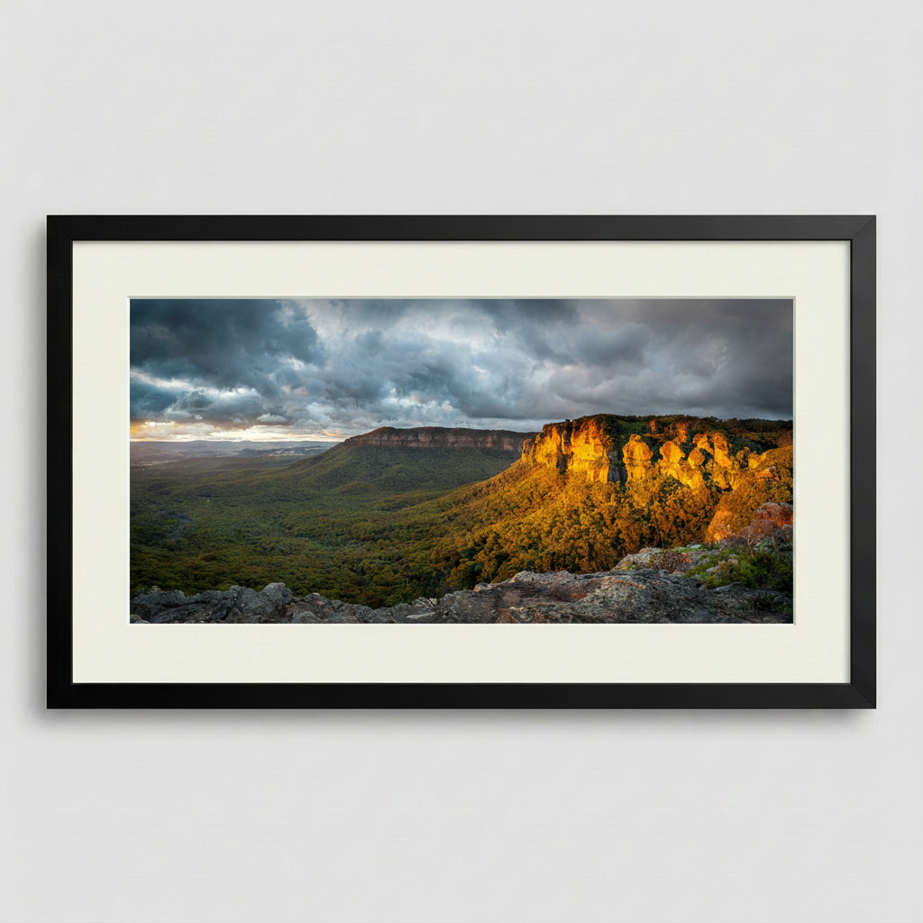 Framed landscape print of the Blue Mountains in golden sunlight with a black frame
