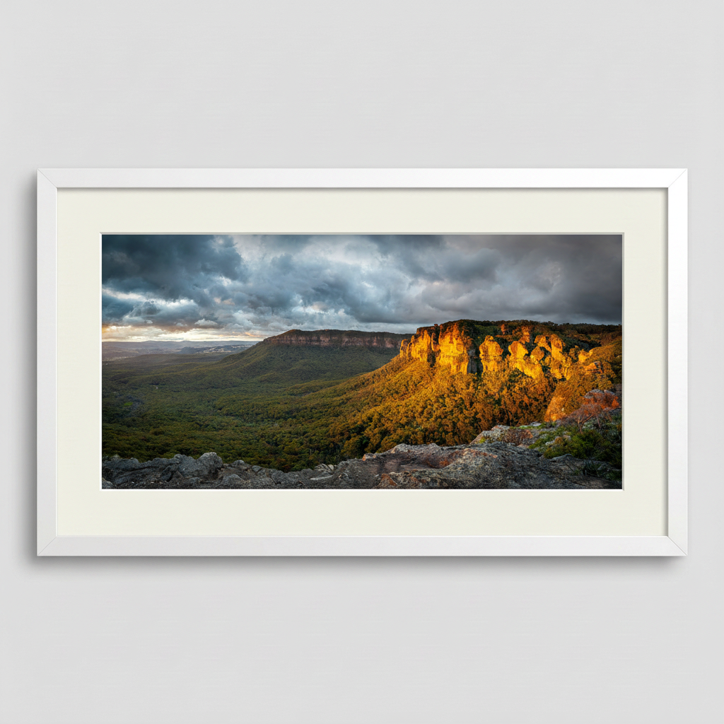 Framed landscape print of the Blue Mountains in golden sunlight with a white frame