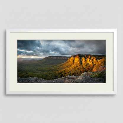 Framed landscape print of the Blue Mountains in golden sunlight with a white frame